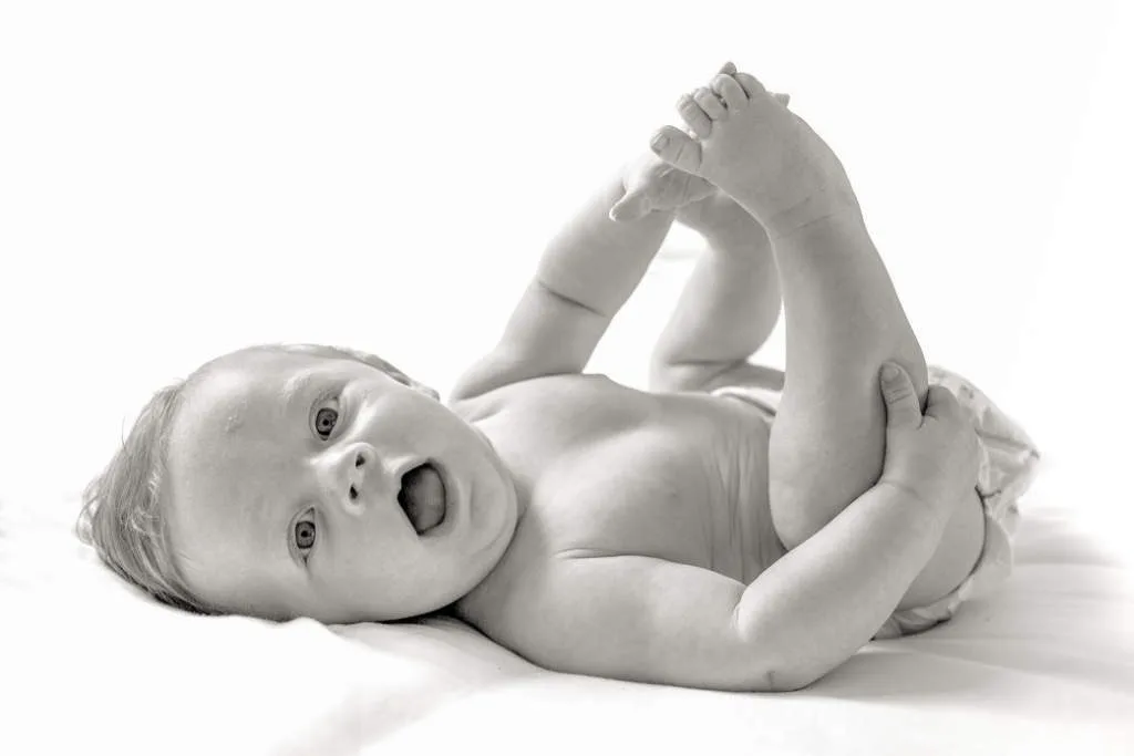 Baby playing with his feet portrait - Bump to Beyond your Birth